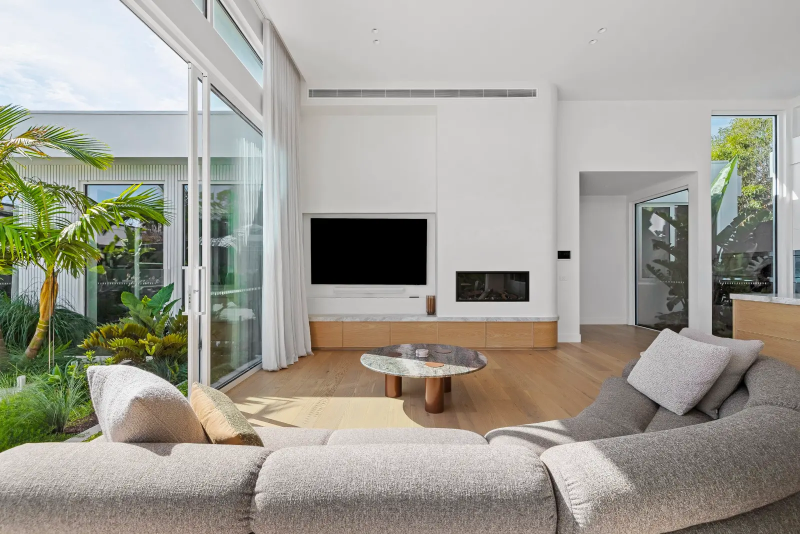 Glasshouse, Mount Eliza. Living room with the screen and fireplace.