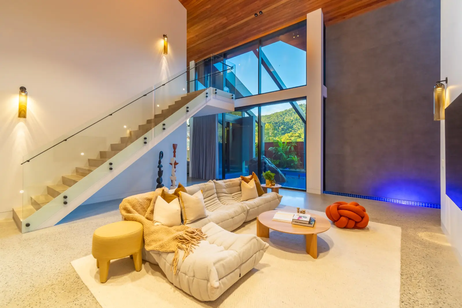 Larimar, Whitsundays. Lounge and stair with the lighting scene set.